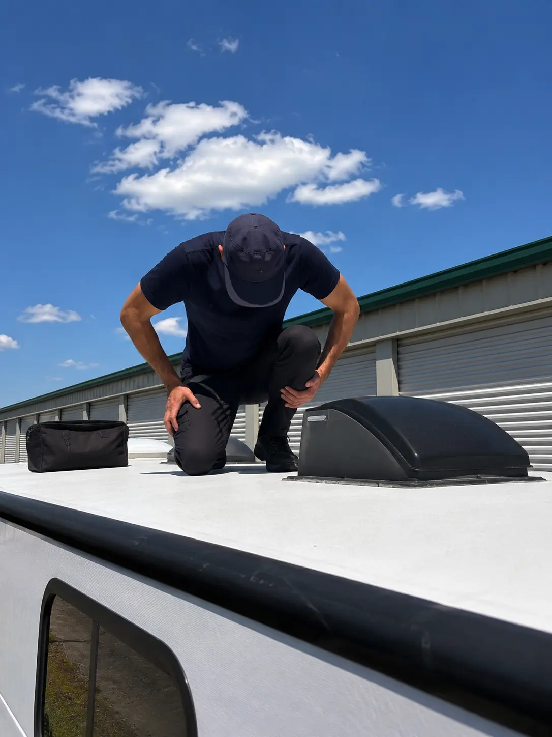 Cincinnati RV Roof Leak and Sealant Repair On-Site RV roof leak repair technician applying Dicor sealant on EPDM roof at storage facility in Cincinnati OH